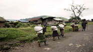 Street scene in North Kivu, DR Congo Women carrying big bags.