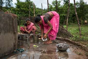 Dürre in Indien Zwei Frauen waschen in einem Brunnen in indien gemeinsam Geschirr.